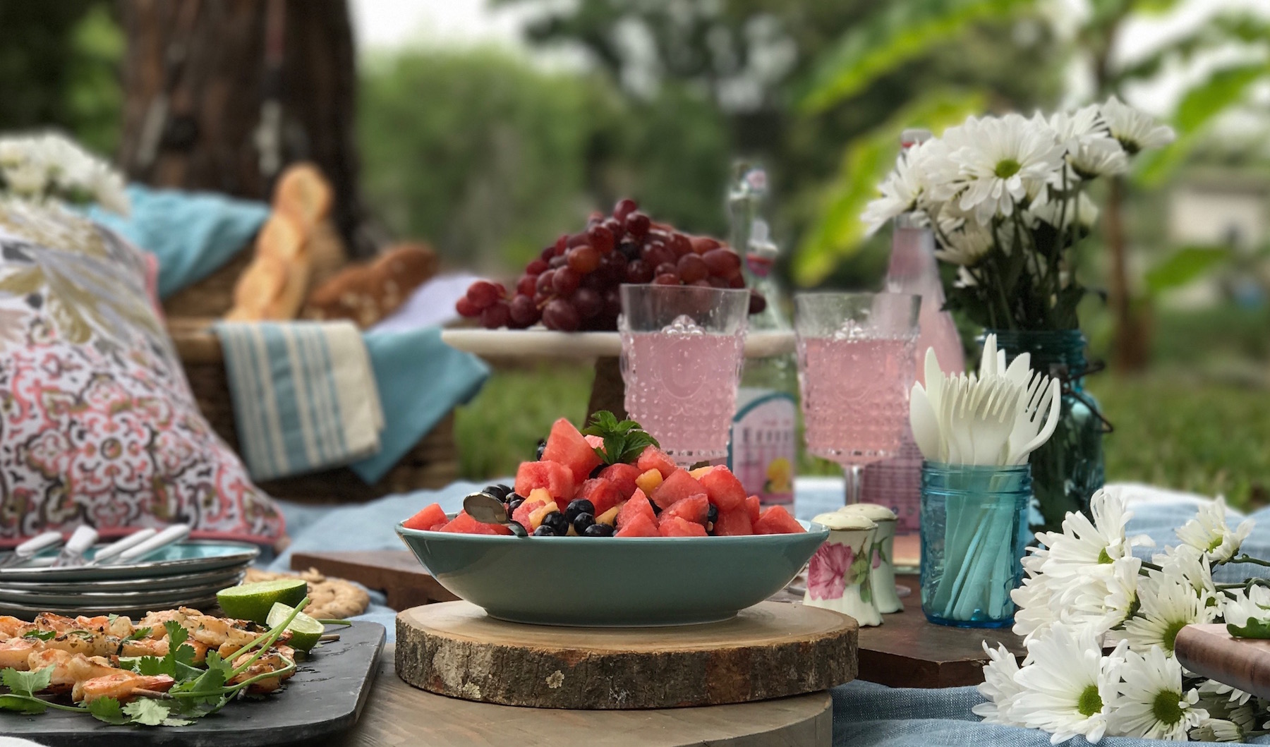 It's a photo of an outdoor table full of food for a buffet or a